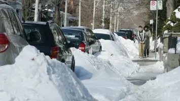 Neighbour discussing parking issue during winter snow