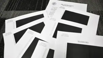 Stack of documents labeled Epstein File Release